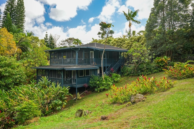 6052 Hauiki Rd Unit 1, Kapaa, HI 96746 - rear view of house with a sunroom, a yard, and stairs
