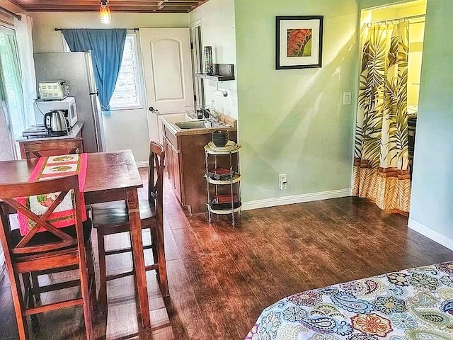 6052 Hauiki Rd Unit 1, Kapaa, HI 96746 - dining space featuring dark wood finished floors and baseboards