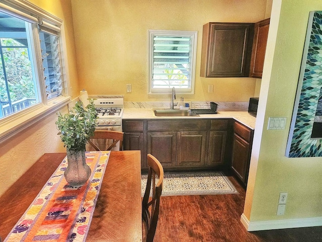 6052 Hauiki Rd Unit 1, Kapaa, HI 96746 - kitchen featuring a sink, dark wood-style floors, light countertops, white gas stove, and black microwave
