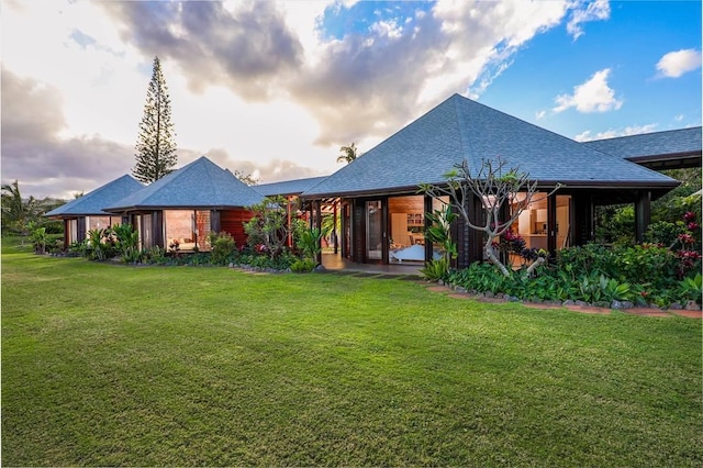 7218-C Koolau Rd, Kilauea, HI 96754 - rear view of property featuring a lawn and a shingled roof