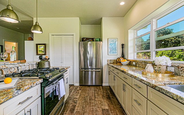 28-387 Kulaimano Rd, Pepeekeo, HI 96783 - kitchen with freestanding refrigerator, range with gas cooktop, hanging light fixtures, light stone countertops, and recessed lighting