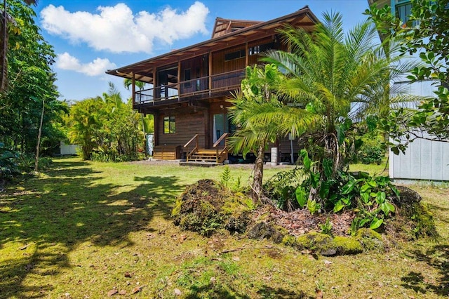 12-7158 Loke Pl, Pahoa, HI 96778 - back of property featuring a balcony and a lawn
