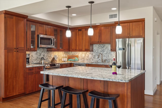 2611 Kiahuna Plantation Dr Unit 2I, Koloa, HI 96756 - kitchen with appliances with stainless steel finishes, a sink, dark wood-type flooring, decorative backsplash, and recessed lighting