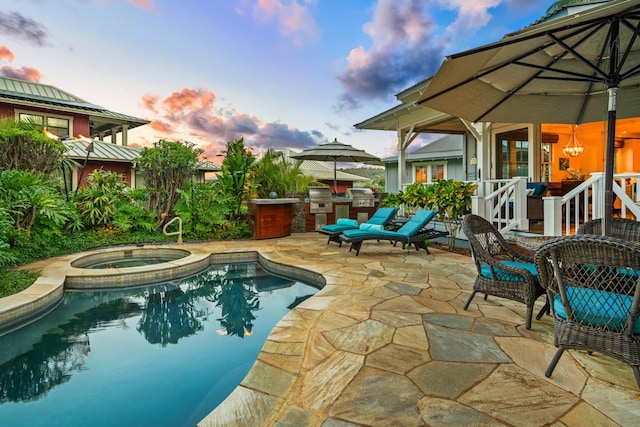 5145 Lau Nahele St, Koloa, HI 96756 - pool at dusk featuring an in-ground hot tub, a patio area, and an outdoor pool