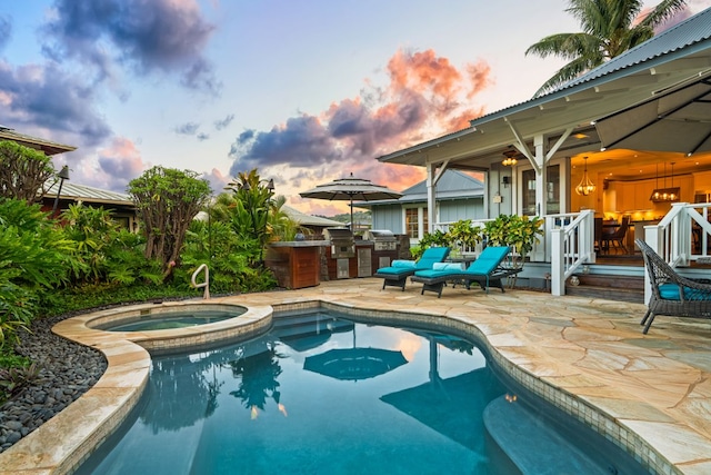5145 Lau Nahele St, Koloa, HI 96756 - pool at dusk with exterior kitchen, an outdoor pool, a patio, and an in-ground hot tub