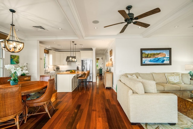 5145 Lau Nahele St, Koloa, HI 96756 - living room with dark wood finished floors, a chandelier, a ceiling fan, and ornamental molding