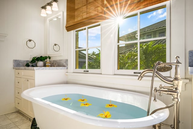5145 Lau Nahele St, Koloa, HI 96756 - bathroom with a freestanding bath, healthy amount of natural light, and marble look tile flooring