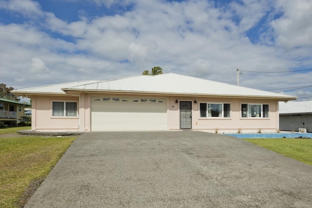 76 Makani Cir, Hilo, HI 96720 - ranch-style home featuring asphalt driveway, a garage, stucco siding, a front yard, and metal roof