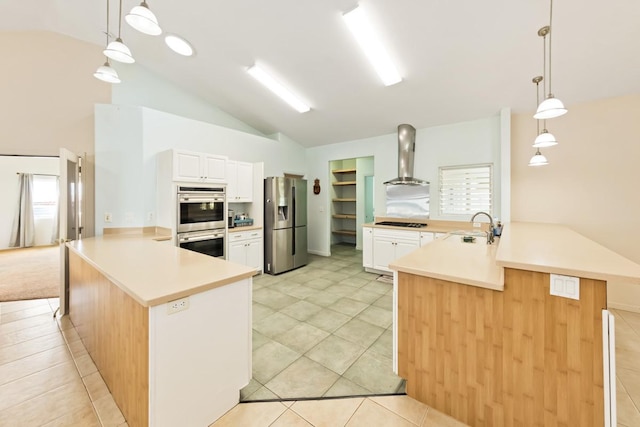 76 Makani Cir, Hilo, HI 96720 - kitchen featuring stainless steel appliances, wall chimney exhaust hood, a peninsula, lofted ceiling, and white cabinets