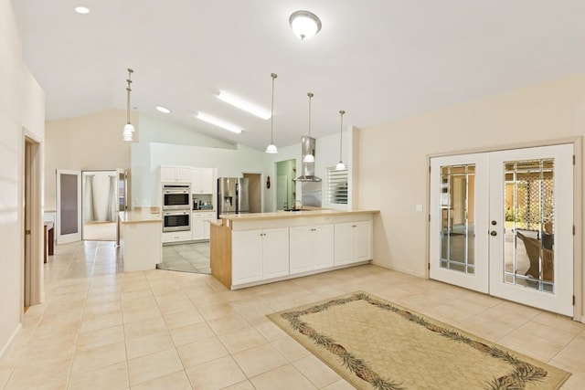 76 Makani Cir, Hilo, HI 96720 - kitchen with appliances with stainless steel finishes, french doors, light tile patterned flooring, a peninsula, and white cabinets
