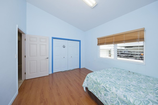 76 Makani Cir, Hilo, HI 96720 - bedroom featuring wood finished floors, baseboards, a closet, and high vaulted ceiling