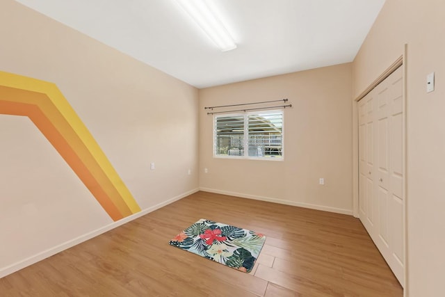 76 Makani Cir, Hilo, HI 96720 - unfurnished bedroom with wood finished floors, baseboards, and a closet