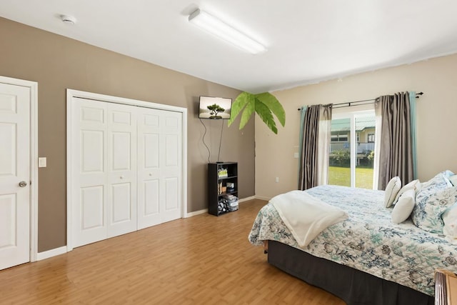 76 Makani Cir, Hilo, HI 96720 - bedroom with wood finished floors, baseboards, access to outside, and a closet