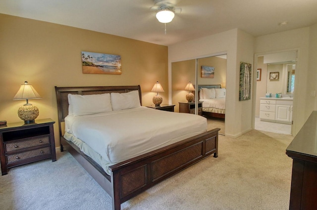 5250 Ka Haku Rd Unit 523, Princeville, HI 96722 - bedroom with light colored carpet, a closet, ensuite bathroom, a ceiling fan, and baseboards