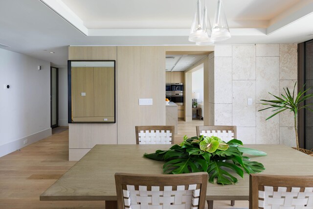 66-84 Kaunaoa Dr Unit C41, Kamuela, HI 96743 - dining area with light wood-type flooring and a tray ceiling