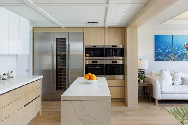 66-84 Kaunaoa Dr Unit C41, Kamuela, HI 96743 - kitchen with appliances with stainless steel finishes, modern cabinets, light wood finished floors, beam ceiling, and light stone counters