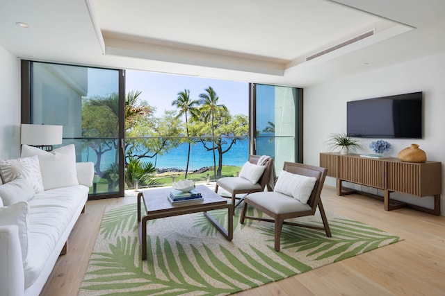 66-84 Kaunaoa Dr Unit C41, Kamuela, HI 96743 - living area with a wall of windows, a tray ceiling, healthy amount of natural light, wood finished floors, and recessed lighting