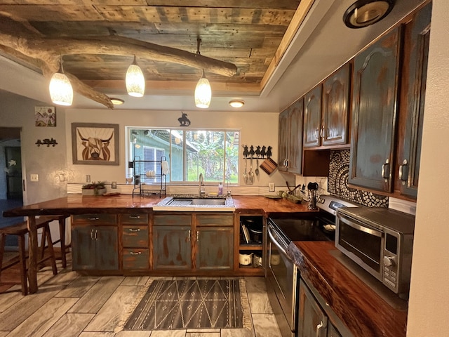 15-1784 30th Ave, Keaau, HI 96749 - kitchen with a sink, stainless steel range with electric stovetop, dark brown cabinetry, a raised ceiling, and hanging light fixtures