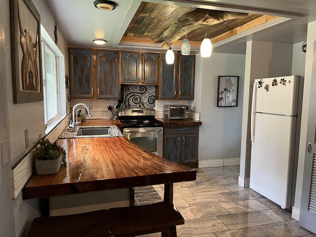 15-1784 30th Ave, Keaau, HI 96749 - kitchen featuring freestanding refrigerator, a sink, stainless steel electric stove, and dark brown cabinetry
