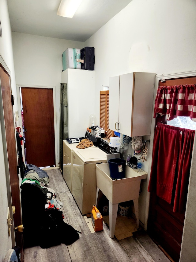 15-2774 Aweoweo St, Pahoa, HI 96778 - laundry area featuring cabinet space, independent washer and dryer, and light wood-style floors