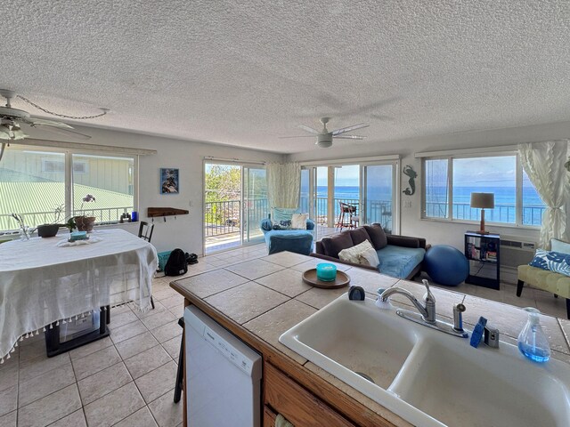 77-6311 Alii Dr Unit 306, Kailua-Kona, HI 96740 - kitchen with a ceiling fan, a sink, dishwasher, open floor plan, and a textured ceiling