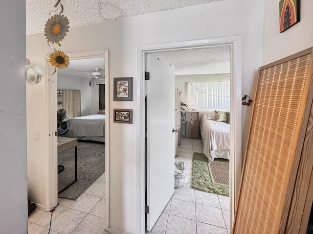 77-6311 Alii Dr Unit 306, Kailua-Kona, HI 96740 - hallway featuring a textured ceiling and light tile patterned floors