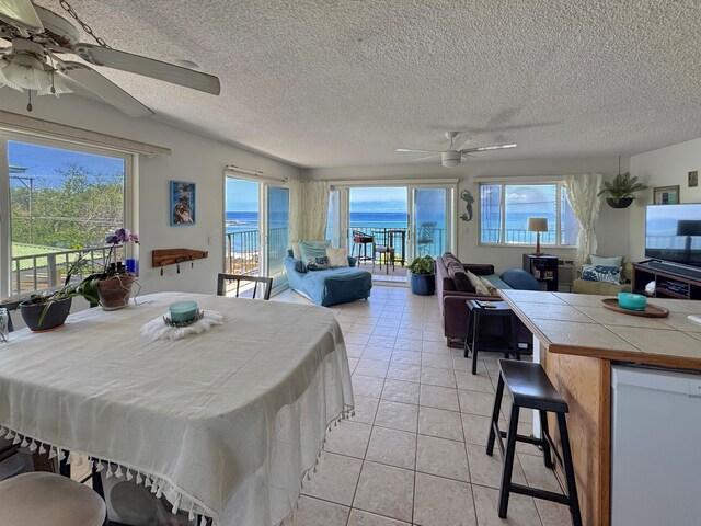 77-6311 Alii Dr Unit 306, Kailua-Kona, HI 96740 - dining room featuring a ceiling fan, a textured ceiling, and light tile patterned floors