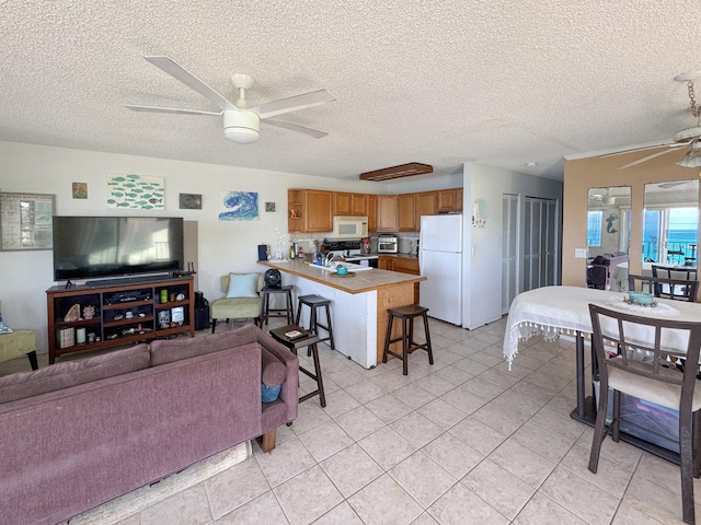 77-6311 Alii Dr Unit 306, Kailua-Kona, HI 96740 - living area with a ceiling fan, a textured ceiling, and light tile patterned floors