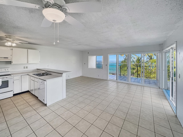 77-6311 Alii Dr Unit 301, Kailua-Kona, HI 96740 - kitchen with white appliances, under cabinet range hood, a sink, open floor plan, and a peninsula