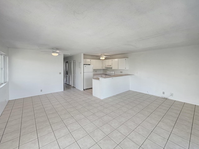 77-6311 Alii Dr Unit 301, Kailua-Kona, HI 96740 - unfurnished living room featuring ceiling fan and a textured ceiling