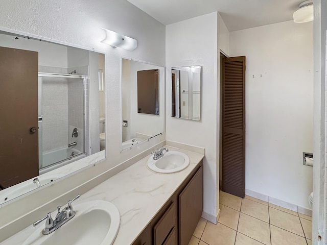 77-6311 Alii Dr Unit 301, Kailua-Kona, HI 96740 - full bathroom featuring toilet, double vanity, tile patterned floors, a closet, and enclosed tub / shower combo