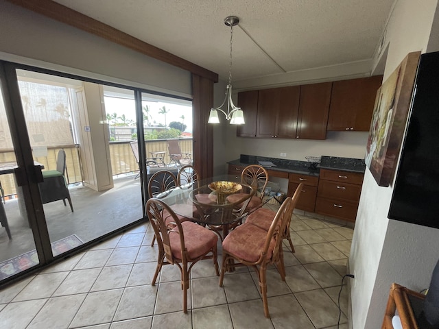 75-5719 Alii Dr Unit 409, Kailua-Kona, HI 96740 - dining area with light tile patterned flooring and a textured ceiling
