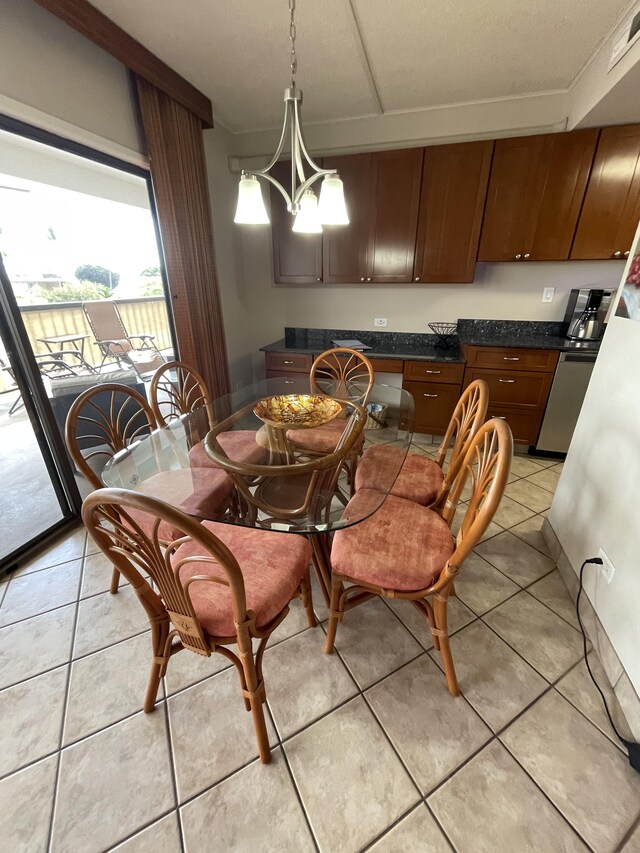 75-5719 Alii Dr Unit 409, Kailua-Kona, HI 96740 - dining area featuring a chandelier and light tile patterned floors
