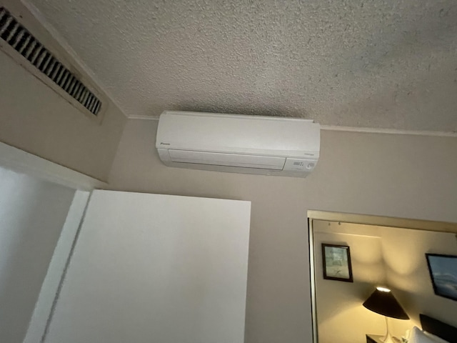 75-5719 Alii Dr Unit 409, Kailua-Kona, HI 96740 - detailed view of a wall mounted AC and a textured ceiling