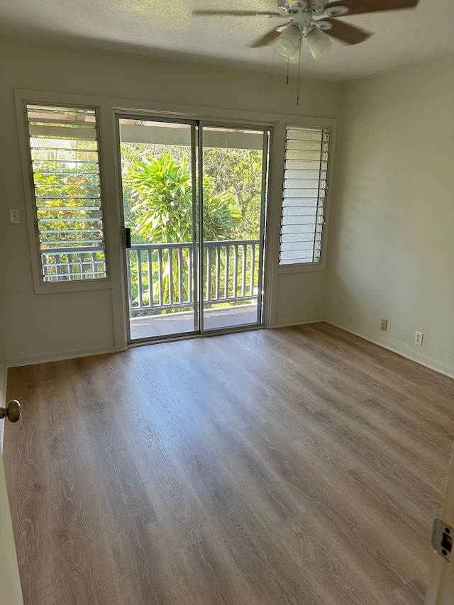 322 Ohai St Unit 16, Hilo, HI 96720 - unfurnished room featuring ceiling fan, wood finished floors, and baseboards