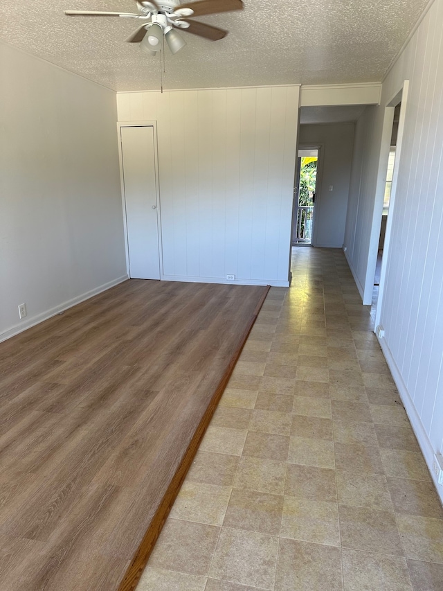 322 Ohai St Unit 16, Hilo, HI 96720 - empty room featuring ceiling fan, a textured ceiling, and baseboards