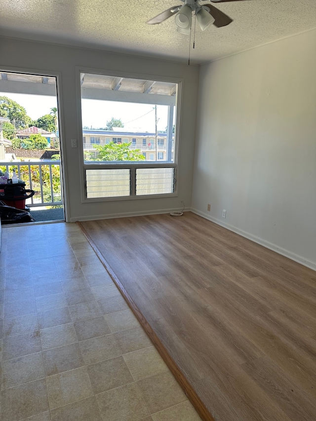 322 Ohai St Unit 16, Hilo, HI 96720 - unfurnished room with ceiling fan, a textured ceiling, and baseboards