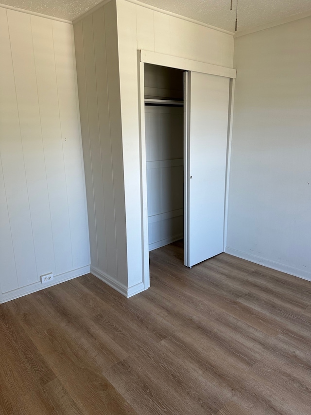 322 Ohai St Unit 16, Hilo, HI 96720 - unfurnished bedroom with wood finished floors, a closet, and baseboards