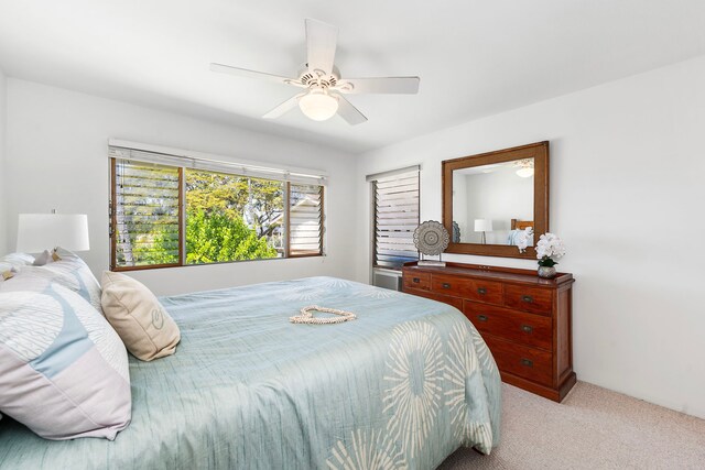 78-7054 Kamehameha Iii Rd Unit 504, Kailua-Kona, HI 96740 - bedroom with light carpet and ceiling fan
