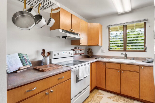 78-7054 Kamehameha Iii Rd Unit 504, Kailua-Kona, HI 96740 - kitchen featuring under cabinet range hood, white range with electric cooktop, a sink, light countertops, and light tile patterned floors