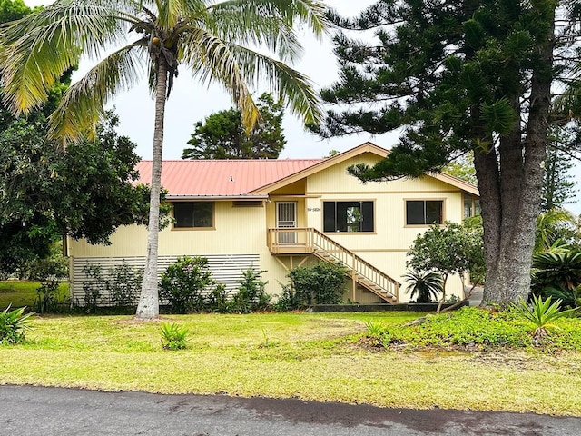 94-5826 Aouli Pl, Naalehu, HI 96772 - view of front of house with a front yard and metal roof