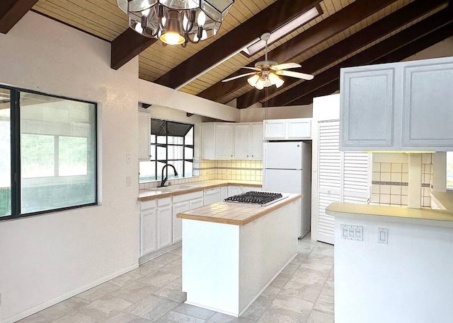 94-5826 Aouli Pl, Naalehu, HI 96772 - kitchen with a sink, wood ceiling, tasteful backsplash, stainless steel gas stovetop, and white cabinets
