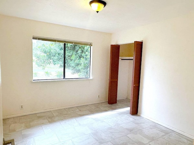 94-5826 Aouli Pl, Naalehu, HI 96772 - unfurnished bedroom featuring baseboards and stone finish floors