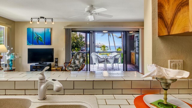 78-261 Manukai St Unit 3501, Kailua-Kona, HI 96740 - tiled living area featuring a ceiling fan, a sink, and a textured wall