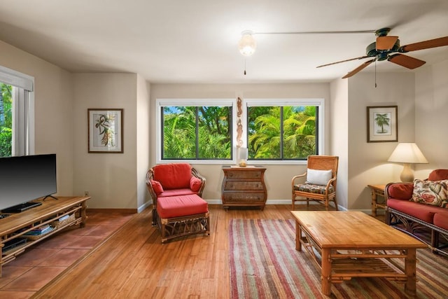 4800 Hanalei Plantation Rd Unit 9B, Princeville, HI 96722 - living area with plenty of natural light, hardwood / wood-style flooring, a ceiling fan, and baseboards