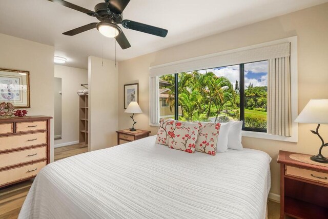 4800 Hanalei Plantation Rd Unit 9B, Princeville, HI 96722 - bedroom with wood finished floors, baseboards, a ceiling fan, and a walk in closet