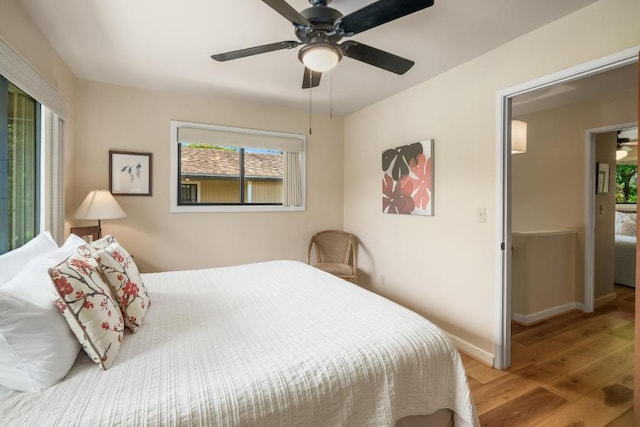 4800 Hanalei Plantation Rd Unit 9B, Princeville, HI 96722 - bedroom featuring multiple windows, wood finished floors, baseboards, and ceiling fan