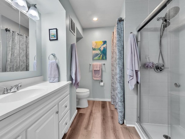 77-6585 Seaview Cir Unit 206, Kailua-Kona, HI 96740 - bathroom featuring vanity, a stall shower, toilet, wood finished floors, and baseboards