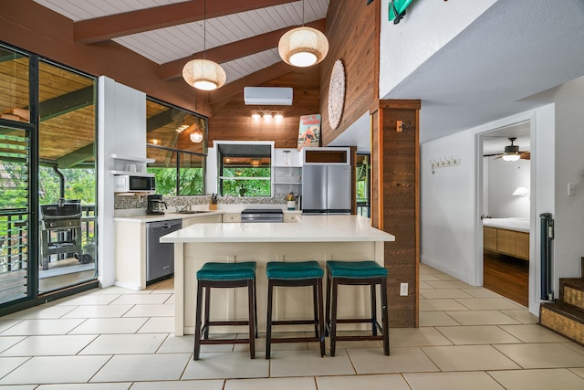 3920 Wyllie Rd Unit 7B, Princeville, HI 96722 - kitchen with appliances with stainless steel finishes, open shelves, light countertops, wood walls, and a kitchen breakfast bar