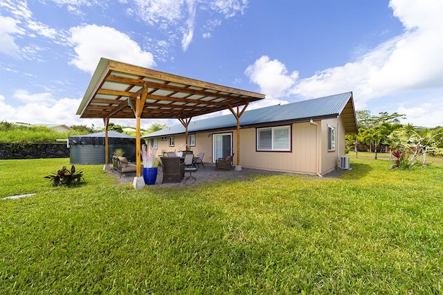 15-2063 18th Ave, Keaau, HI 96749 - rear view of property with a metal roof, a patio area, and a lawn